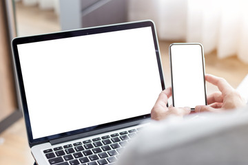 mockup image blank screen computer,cell phone with white background for advertising text,hand man using laptop texting mobile contact business search information on desk in cafe.marketing,design