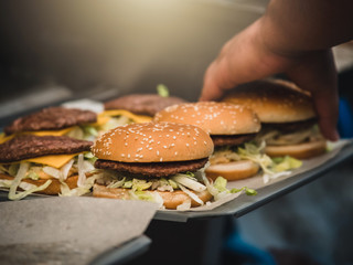 Preparation of burger. Professional chef is preparing burger. Burger making. Cooking hamburger concept.