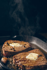 two steaks are fried in a pan. do-it-yourself dinner concept for two. eating at home.