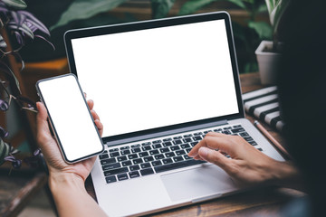 mockup image blank screen computer,cell phone with white background for advertising text,hand woman using laptop texting mobile contact business search information on desk in cafe.marketing,design