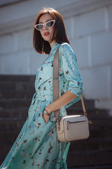 Sticker - Fashion portrait of young stylish woman walking on the street