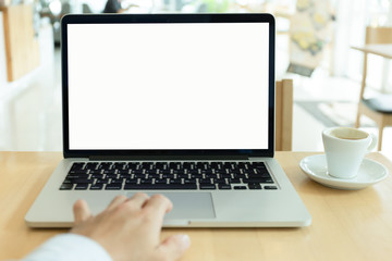 mockup image blank screen computer with white background for advertising text,hand woman using laptop contact business search information on desk at coffee shop.marketing and creative design