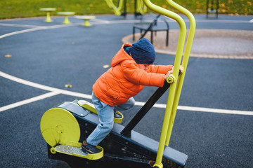 Wall Mural - boy making sport on exerciser