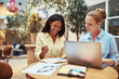 © Flamingo Images - Smiling businesswomen using a laptop in an office lounge