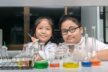 Wall Mural - happy two children making science experiments.