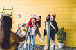 © BullRun - Group of cheerful friends photographing together at home