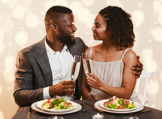 Wall Mural - African man and woman celebrating Valentine's Day at restaurant