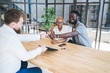 © BullRun - Joyful black couple making deal with realtor