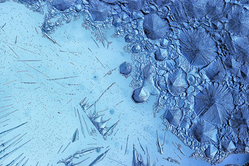 blue ice glass background, abstract texture of the surface of the ice on the glass, frozen seasonal water