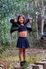 Wall Mural - Cute girl posing with black leather