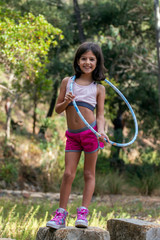 Wall Mural - Cute girl posing with hula hoop