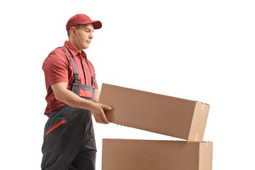 Poster - Male worker placing a box on top of a stack