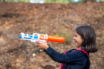 Wall Mural - Cute girl with water gun