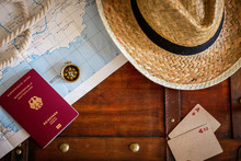 Travel Concept With German Passport, Map Of The Mediterranean, Compass, Straw Hat And Playing Cards