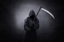 Grim Reaper With Scythe In The Dark