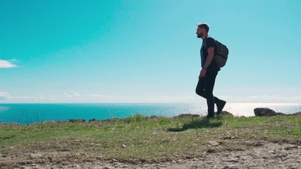 Fototapete - adventure, travel, tourism, hike and people concept - hiking man with backpack looking at sea or ocean in summer