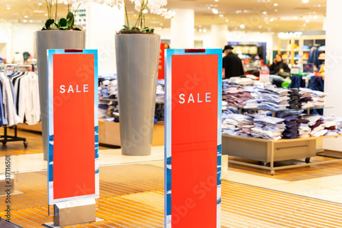 Fotografía Red bright sale word banner on anti-thieft gate sensor at retail shopping mall entrance