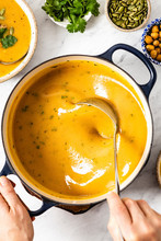 Sweet Potato Soup Being Served From A Pot