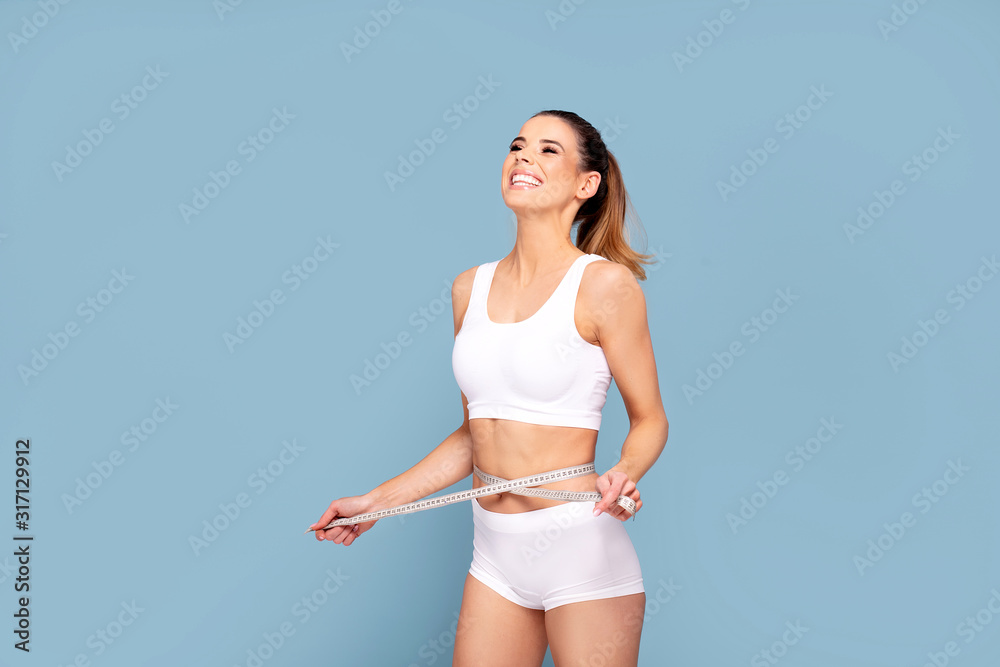 Active happy fit girl with centimeter. - obrazy, fototapety, plakaty 