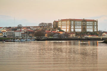 Canvas Print - Santa Clara Convent in Vila do Conde, Portugal, at sunset on an autumn day, with the river Ave in the foreground.