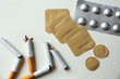 © New Africa - Nicotine patches, pills and broken cigarettes on white background, flat lay