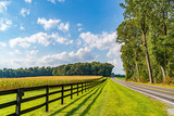 Fototapeta Na ścianę - Amish country field agriculture, beautiful brown wooden fence, farm, barn in Lancaster, PA US