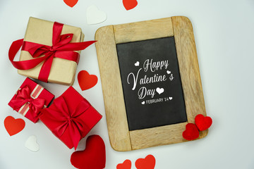 Wall Mural - Table top view aerial image of decoration valentine's day background concept.Flat lay arrangement of blank space blackboard & essential items on modern rustic white wood for mock up creative design