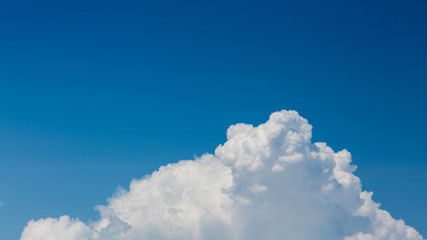 fluffy white cloud above clear blue sky background