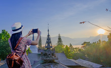Woman Traveller Enjoy Takes Photo Of  Temple View Of Mist And Foggy Morning, Mae Hong Son Province In Thailand, Wat Phra That Doi Kong Mu The Popular For Tourist Place