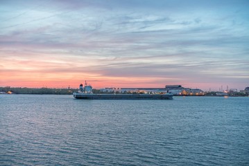 Sticker - Big industrial ship sailing in the sea under the cloudy sky during the sunset