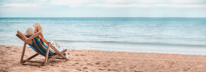 Young happy woman sitting on the chair beach, tropical holiday vacation relax. 