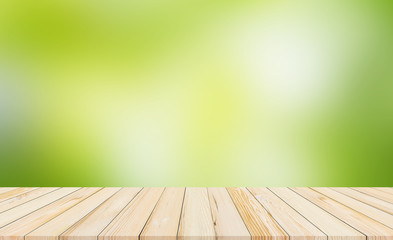 wood desk or wood floor with abstract green blurred background for products display