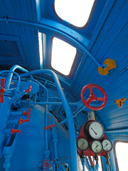 Wall Mural - Old steam engine locomotive control room - lot of handles, valves, pipes and manometers. Blue and red iron details of vintage train. Industrial retro background.