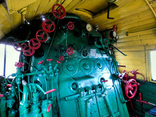 Wall Mural - Old steam engine locomotive control room - big red valve and manometers. Blue and red iron details of vintage train. Industrial retro background.