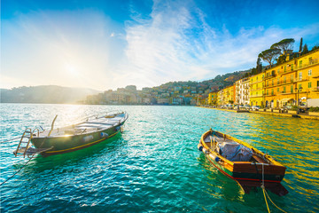 Wall Mural - Wooden small boats in Porto Santo Stefano seafront aty sunrise. Argentario, Tuscany, Italy