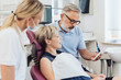 © contrastwerkstatt - Dentist looking at an x-ray with the patient
