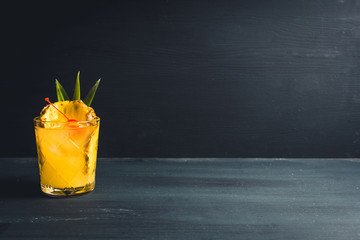 Wall Mural - Old fahioned pineapple beverage on rustic background. Selective focus. Shallow depth of field.