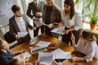 © master1305 - Top view. Group of young business professionals having a meeting. Diverse group of coworkers discuss new decisions, plans, results, strategy. Creativity, workplace, business, finance, teamwork.