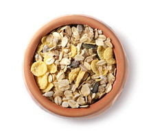 Muesli Mixture Of Wholegrain Foods, Cereals, Seeds And Raisins In Clay Bowl Isolated On White Background, Top View