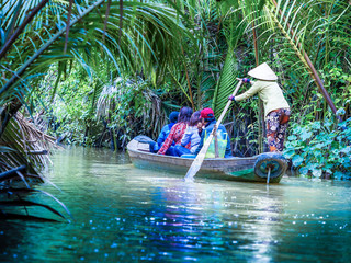 Wall Mural - tourist enjoying mekong delta cruise with canoe on vietnam