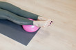 © junky_jess - Female barefooted feet on small fit ball, close up. Caucasian woman in sporty leggings lying on the floor in loft fitness studio indoors, selective focus.