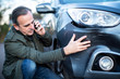 Unhappy Mature  Male Driver With Damaged Car After Accident Calling Insurance Company On Mobile Phone