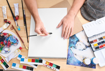 Wall Mural - Young male artist working in studio