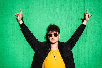 Portrait of a guy dressed modern in the street with sunglasses. Teenager Social Networking style photo