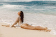 Beautiful young woman in bikini relax at tropical beach. Sexy model at ocean coast