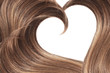 Brown hair in shape of heart on white, isolated