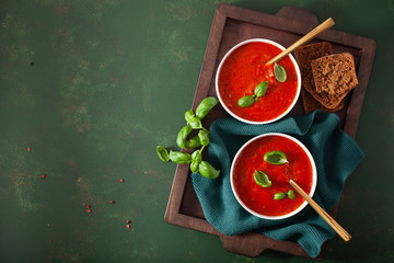 Wall Mural - tomato and bell pepper vegetarian soup on green background