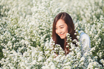 Wall Mural - Portrait image of an asian woman in a beautiful Cutter flower field