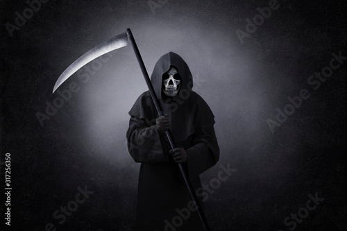 Fotografía Grim reaper with scythe in the dark