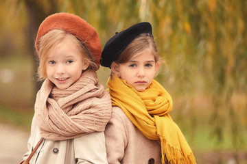 Sticker - Cute little girls in autumn clothes outdoors